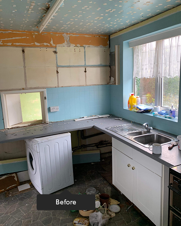 Old demolished kitchen with white cupboards and dark coloured lino